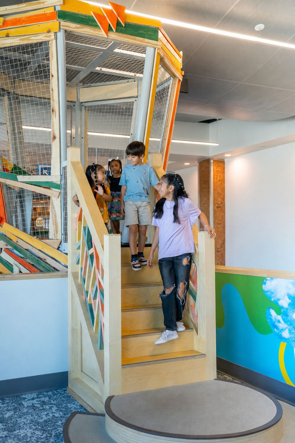Children coming down the stairs of the Backyard Tower Climber