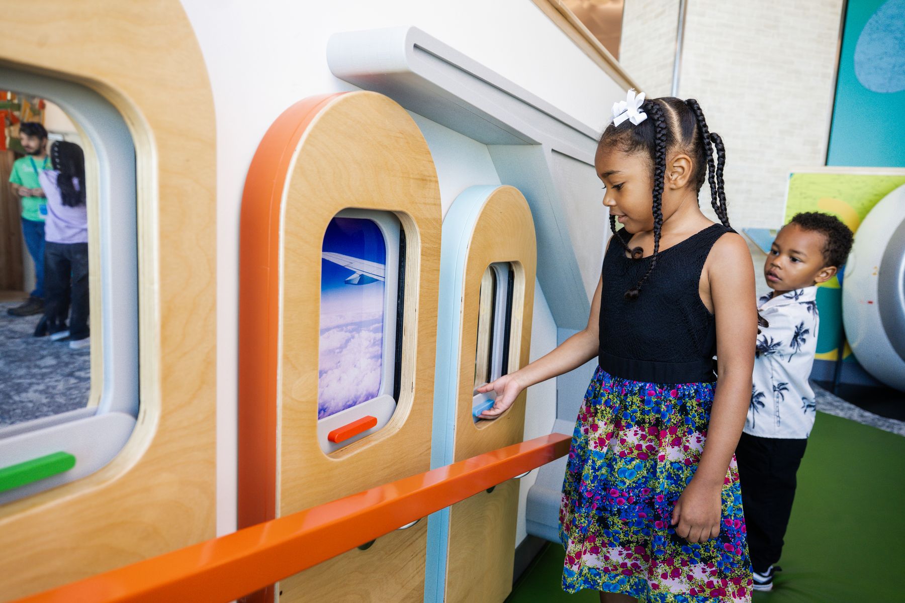 Children exploring the airplane-window interactives at Wonder Wing, Northwest Arkansas National Airport