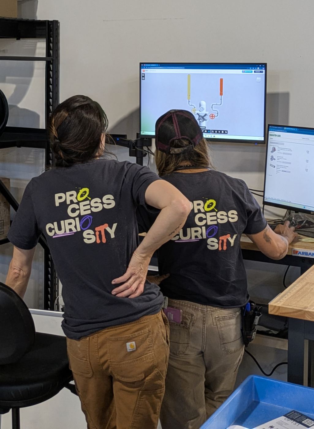Brooke and Kam reviewing a design at the shop computer