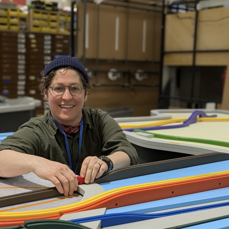 Dana Schloss, Chief Design Officer, assembling a track exhibit in the shop